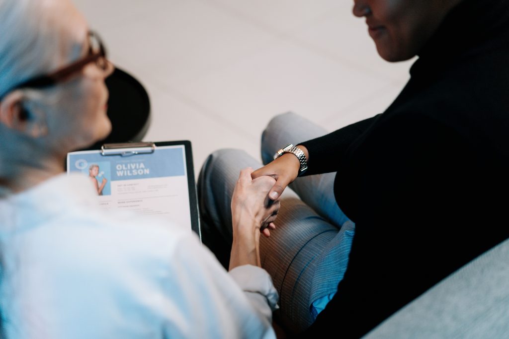 Researcher reviewing a printed CV with a career consultant
