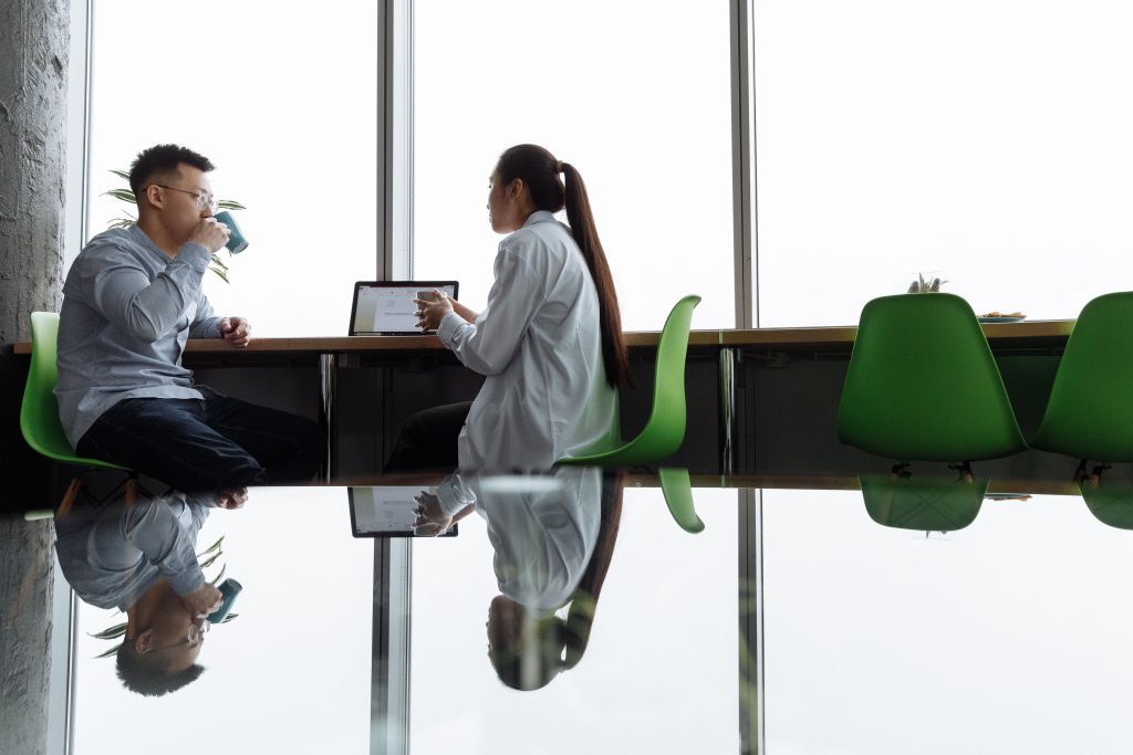 Two researchers in a lab having a calm conversation at a bench